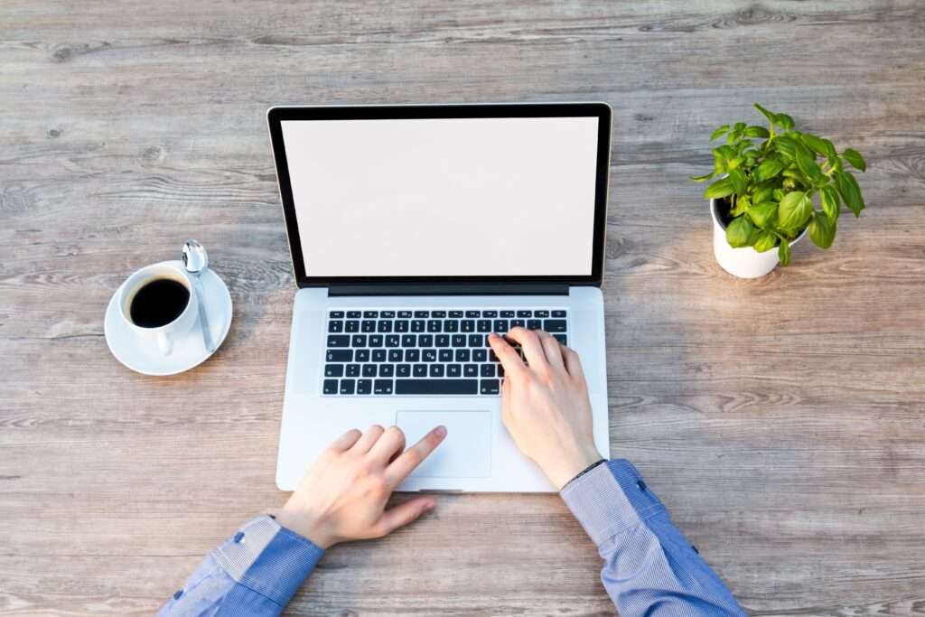 Side Income Ideas_ Freelancing. This image shows a hand of a man typing on a MacBook.